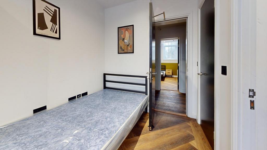 A bright and stylish double bedroom featuring m...