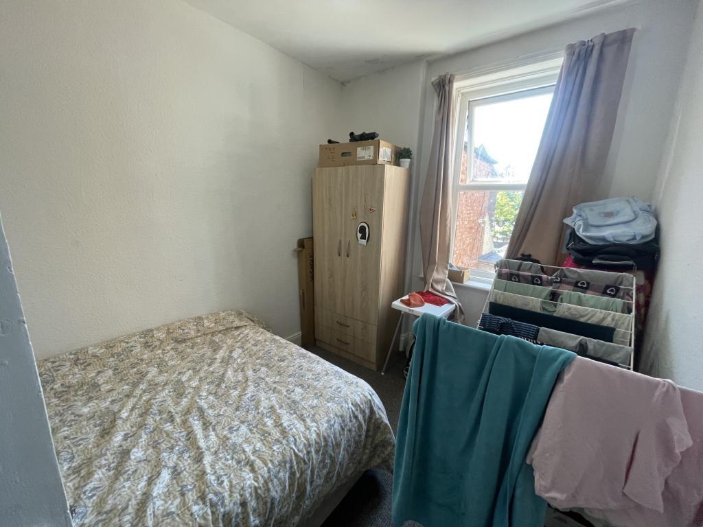 Cozy double bedroom featuring a comfortable bed...