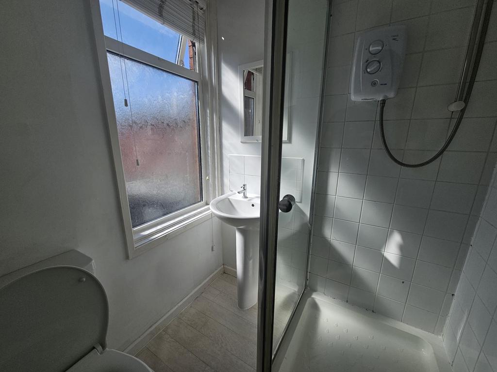 A clean and well-maintained bathroom with a sho...