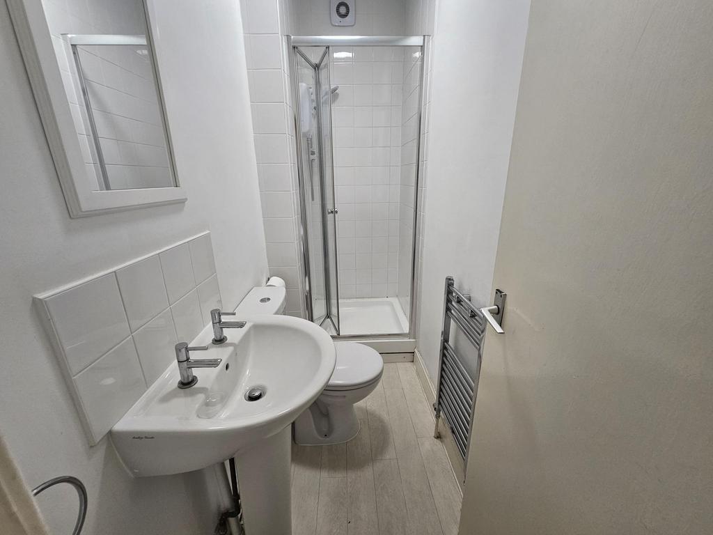 A clean and modern bathroom with a walk-in show...