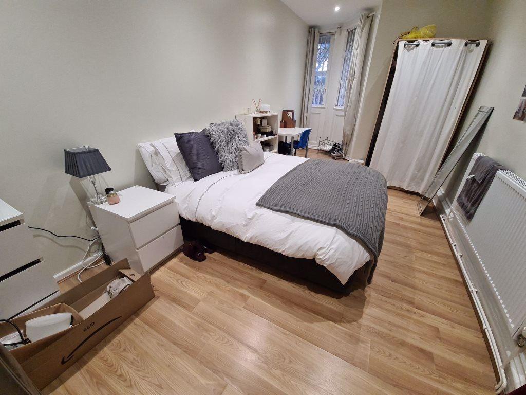 A cozy and well-maintained bedroom featuring a ...