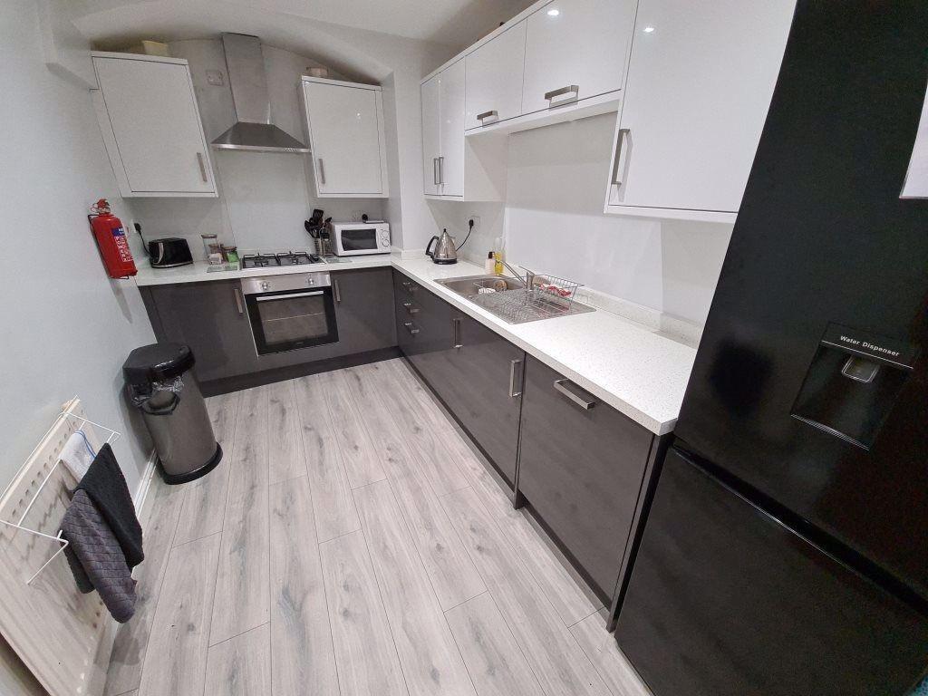 Modern, well-maintained kitchen with ample work...