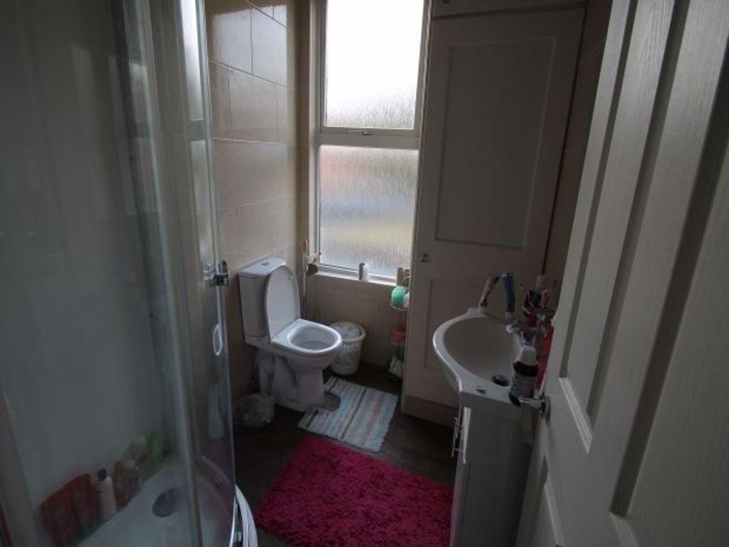 A clean and functional bathroom featuring a sho...