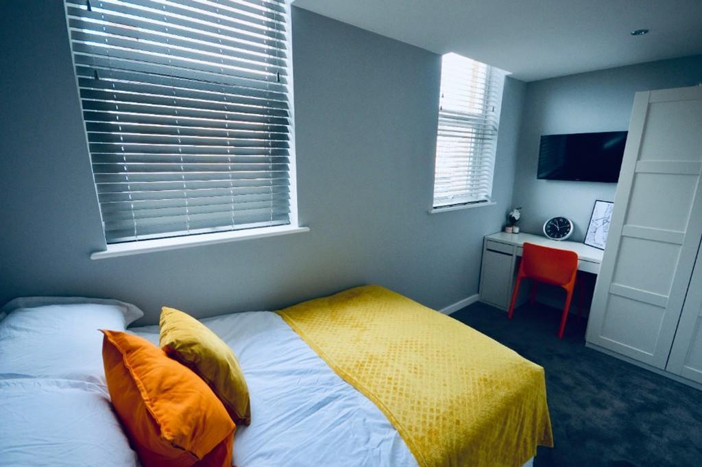 A bright and inviting double bedroom with moder...