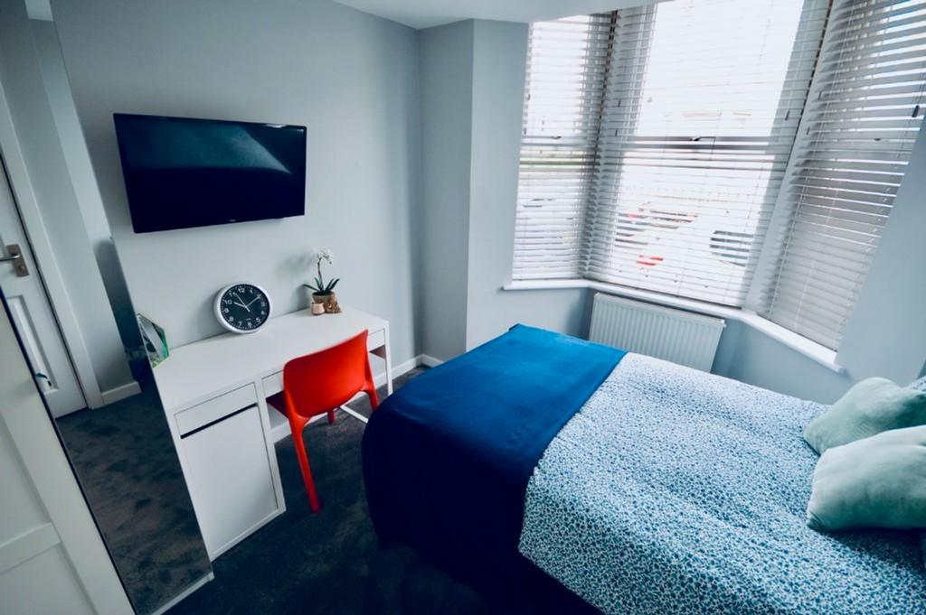 A bright and inviting double bedroom featuring ...