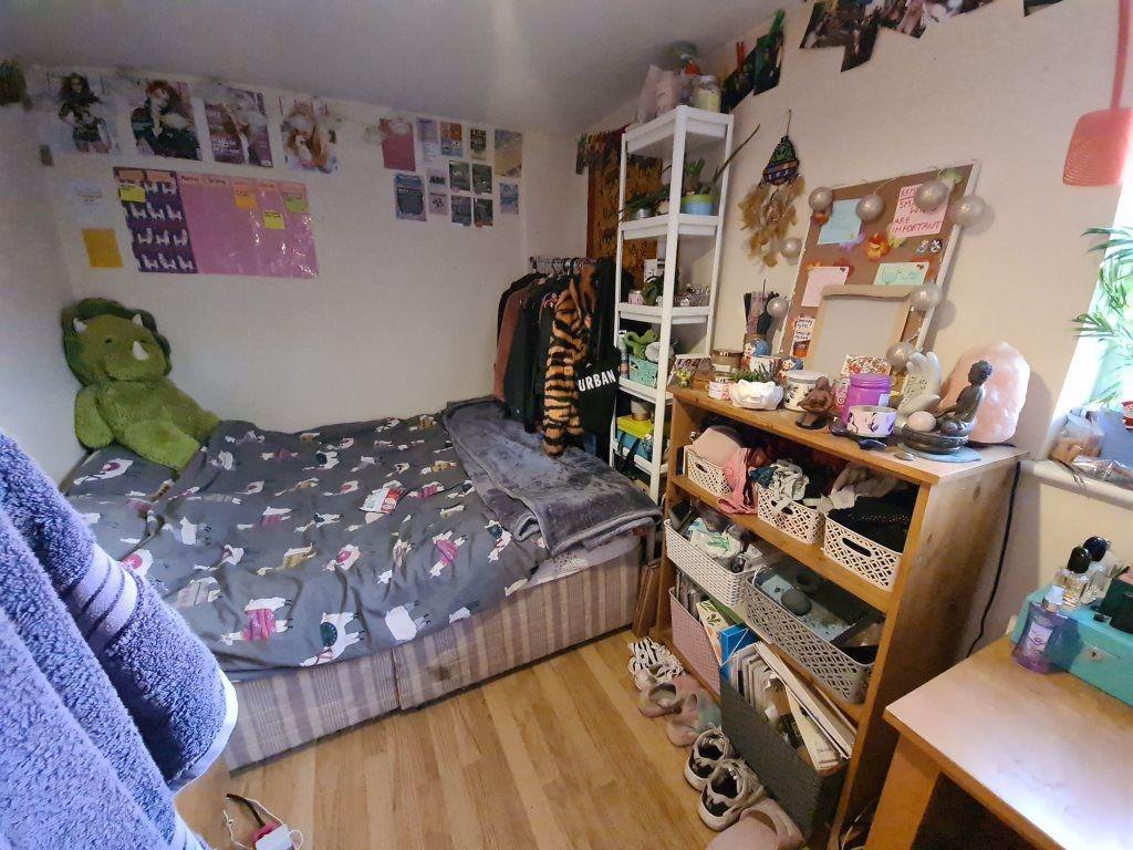 Cozy single bedroom featuring a comfortable bed...
