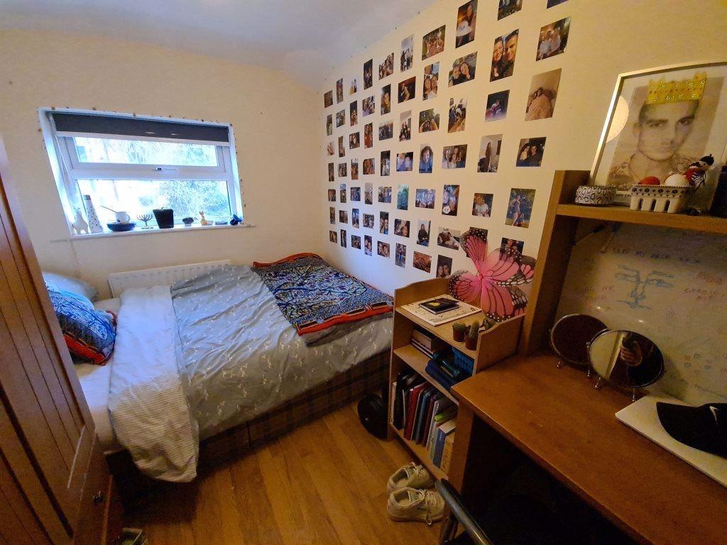 Cozy single bedroom featuring a comfortable bed...