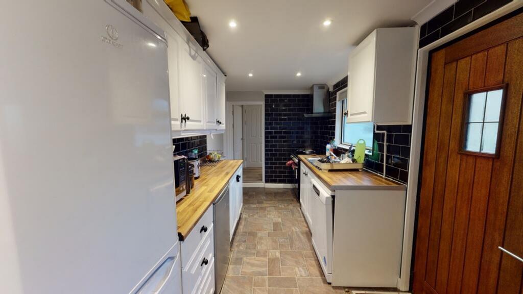 A modern kitchen featuring sleek cabinetry and ...