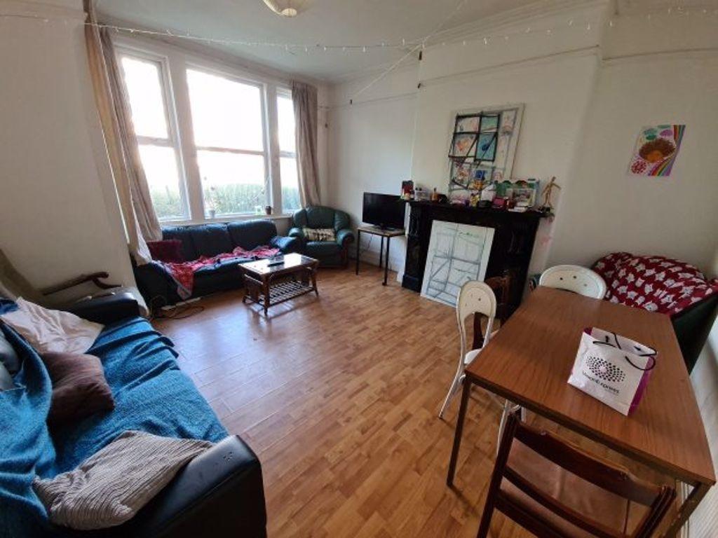 A cozy living room with ample natural light com...