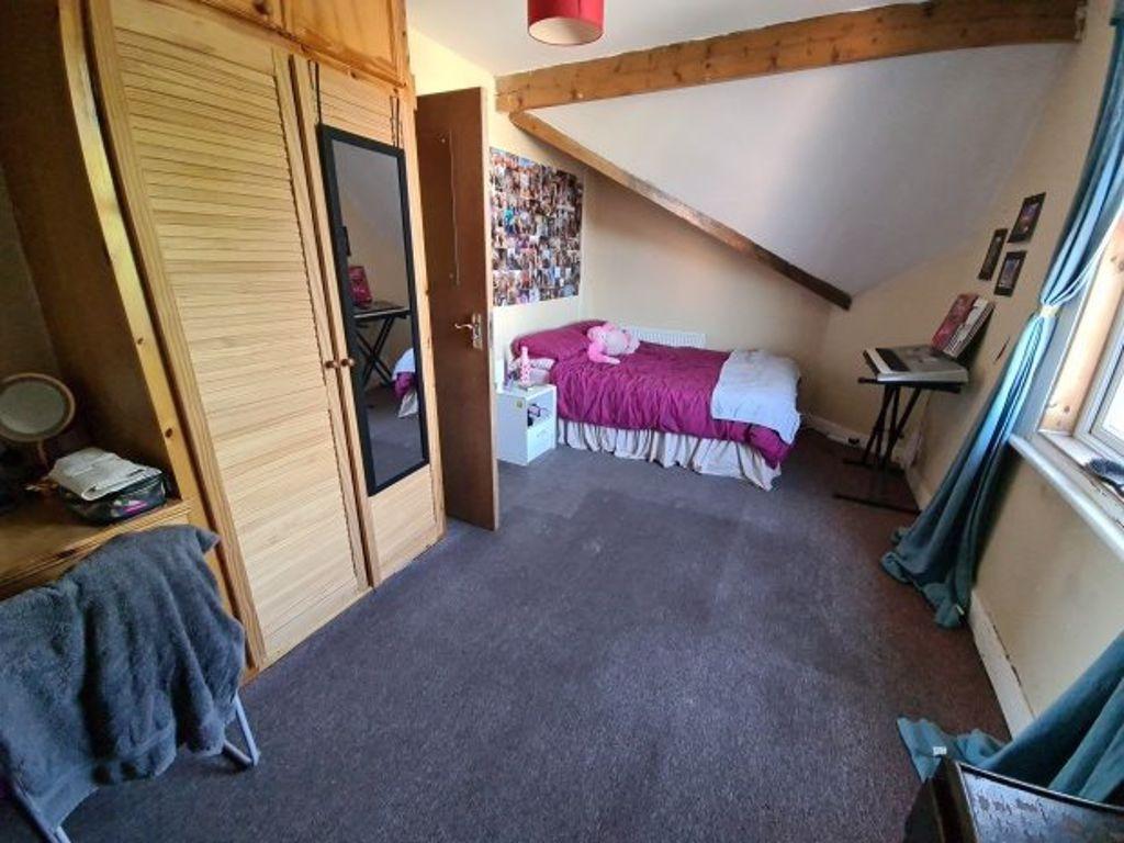 Cozy single bedroom featuring a comfortable bed...