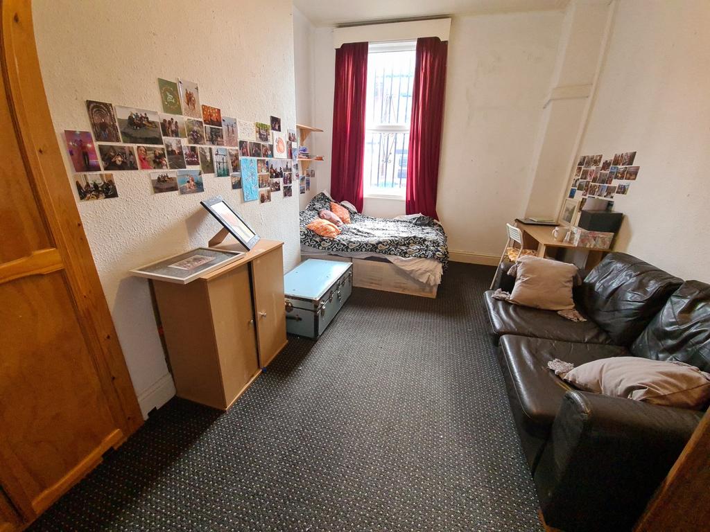 Cozy room featuring a comfortable bed with brig...