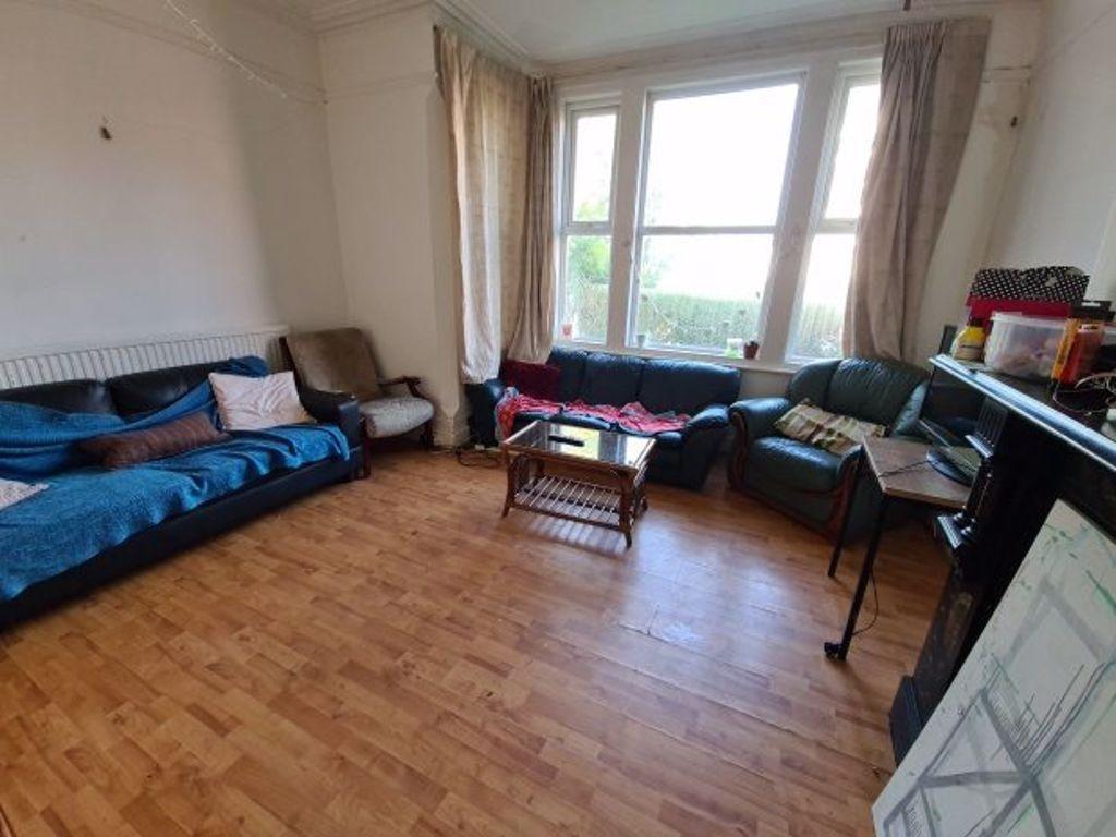 Bright and welcoming living room with large bay...