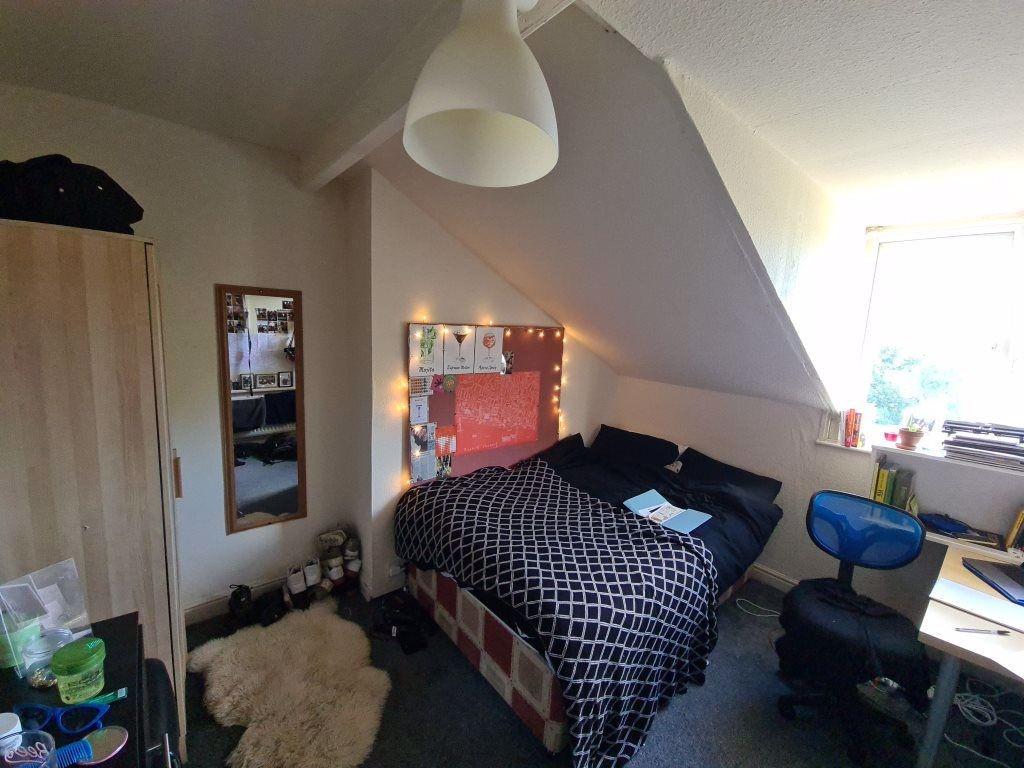 A well-maintained bedroom featuring a double be...