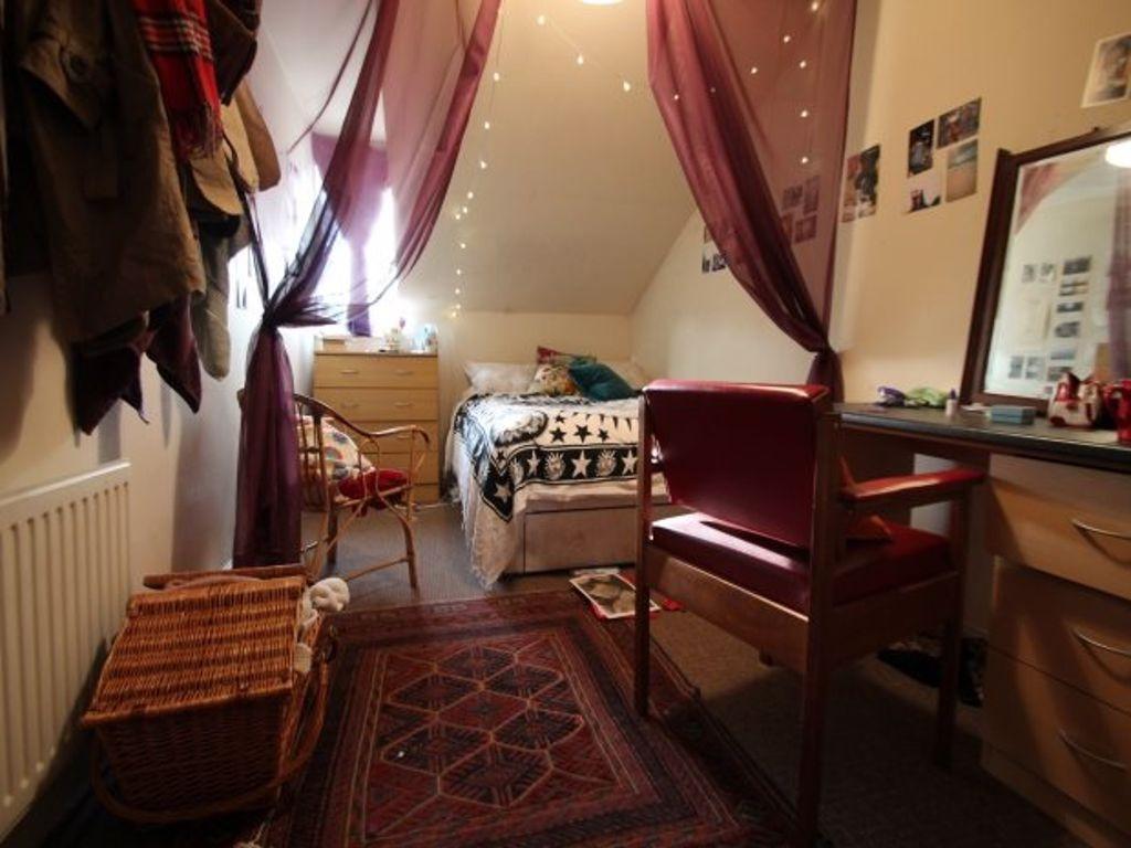 A cozy and well-maintained bedroom featuring a ...