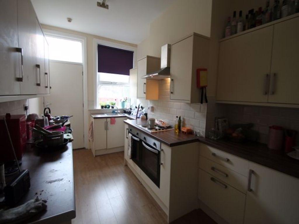 A compact kitchen area featuring essential appl...