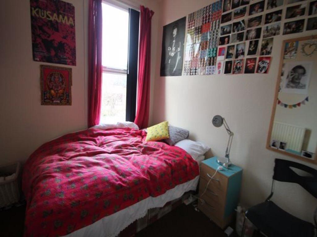 A cozy bedroom featuring a double bed with a vi...