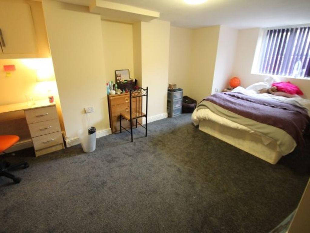 A spacious double bedroom featuring a comfortab...