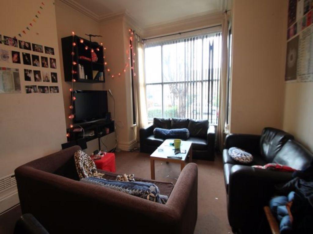 A cozy and well-lit living room featuring comfo...