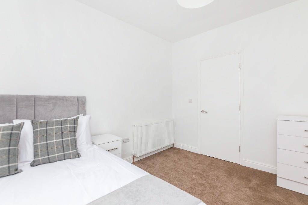 A neat and bright double bedroom featuring a co...