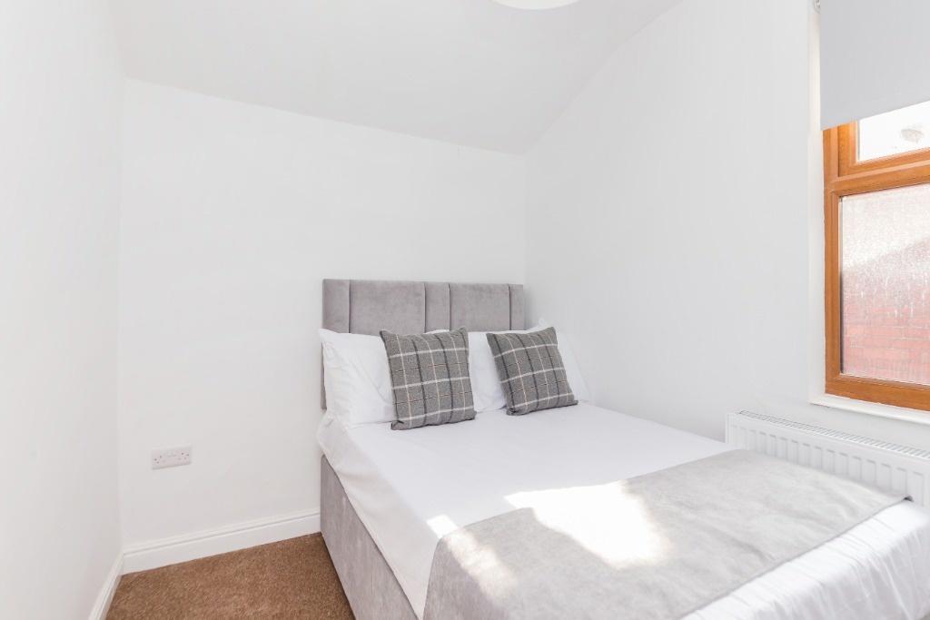 Bright and tidy double bedroom featuring a comf...