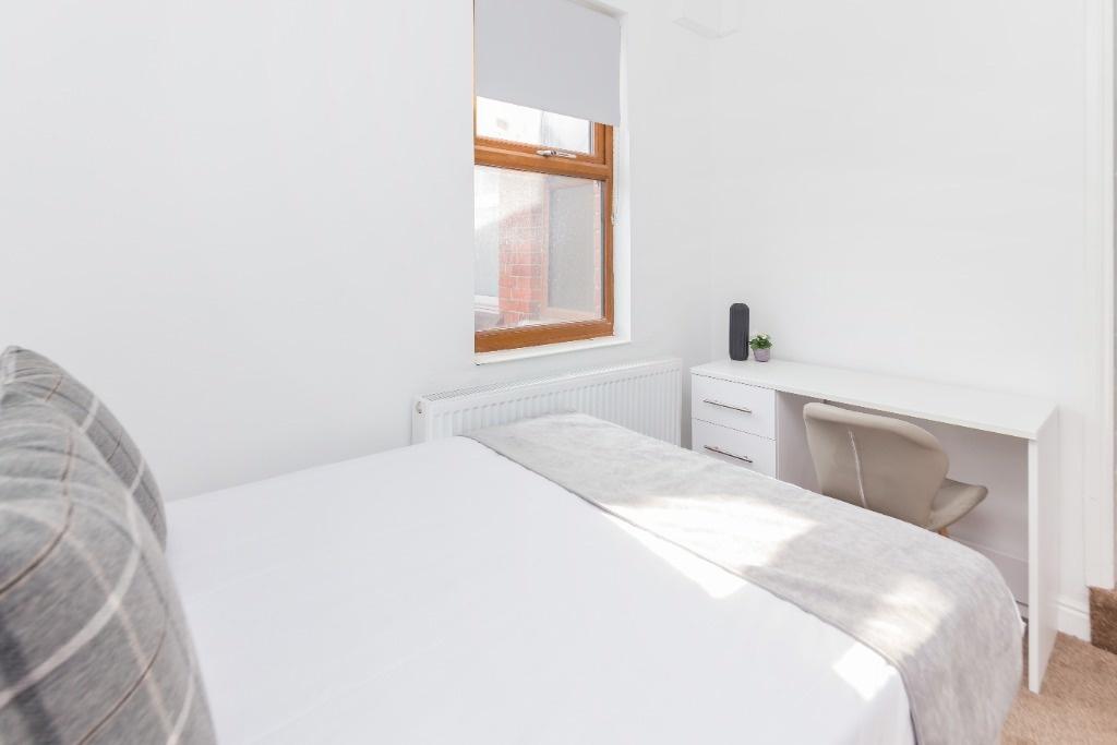 Bright and cozy double bedroom featuring a comf...