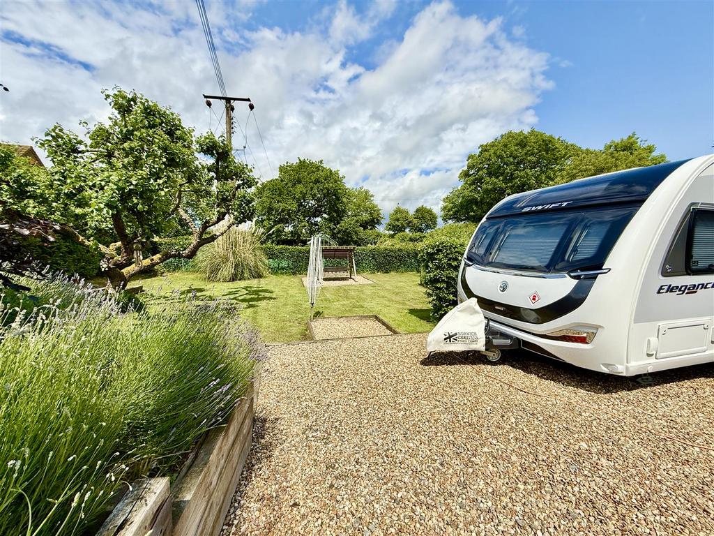Driveway leading to space for caravan