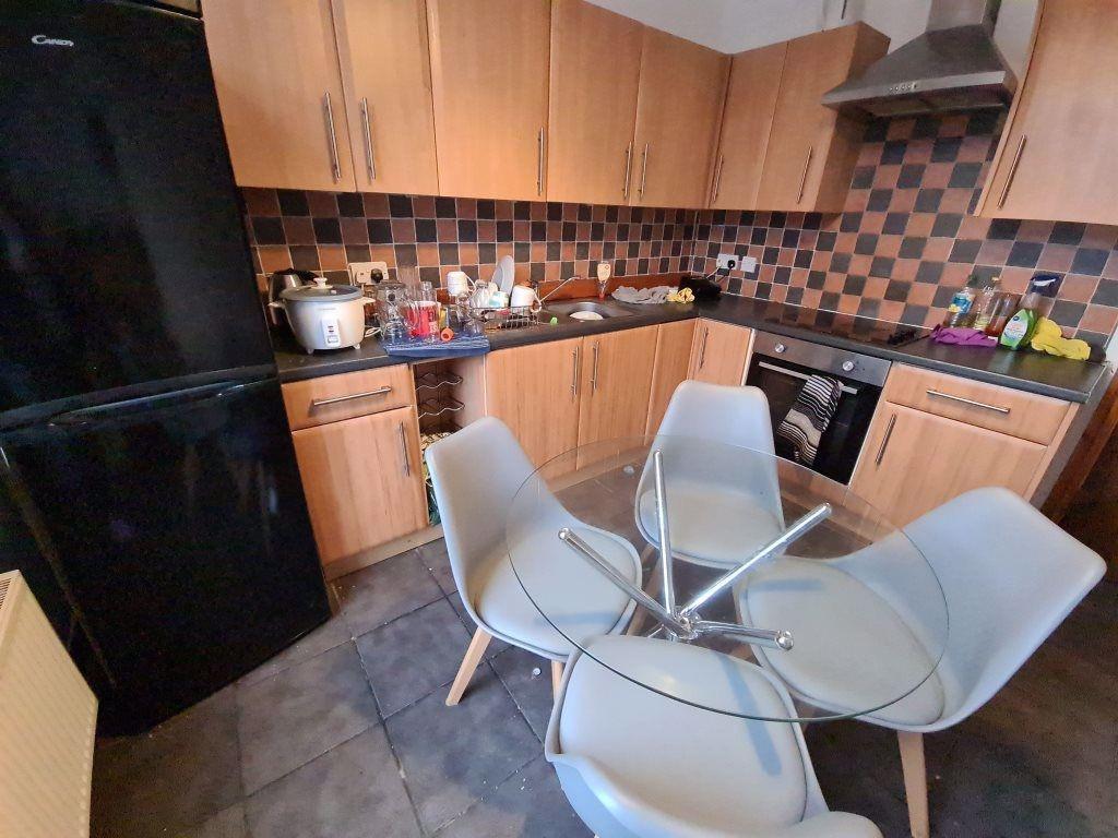 Modern kitchen with wooden cabinetry and a tile...