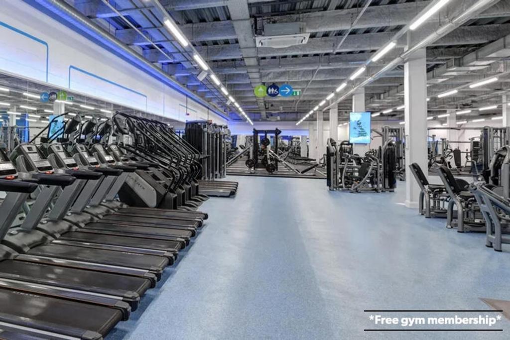 A spacious and modern gym filled with a variety...