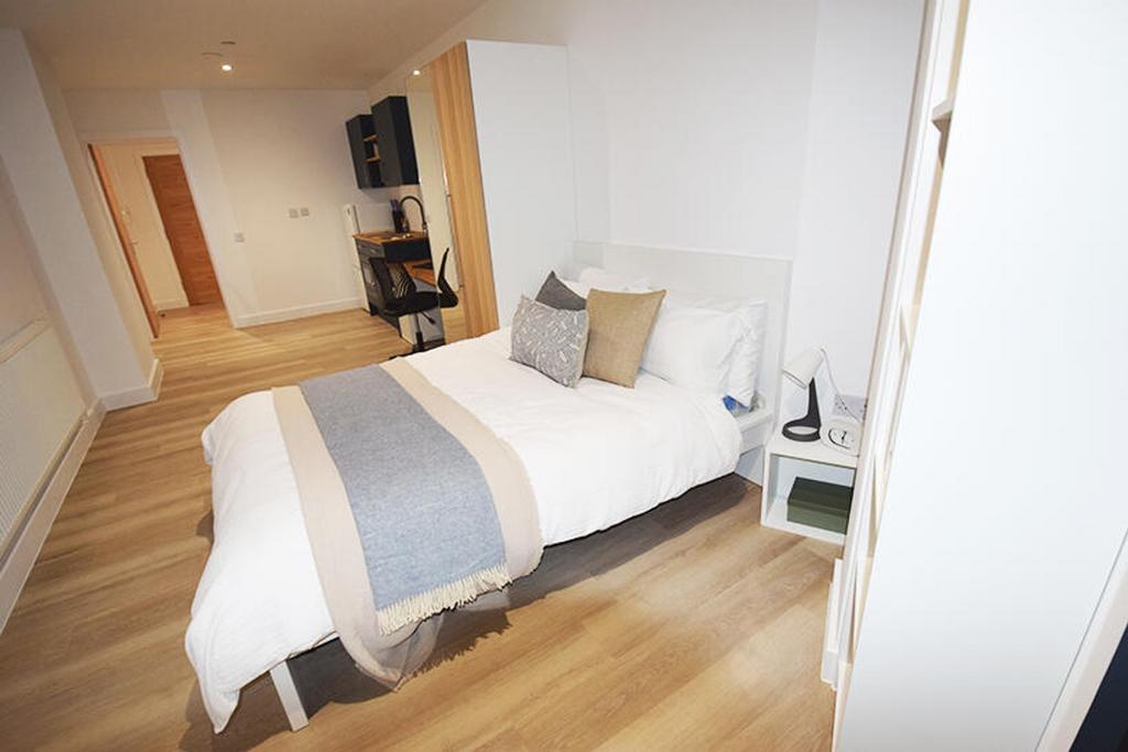 This stylish double bedroom offers a cozy retre...