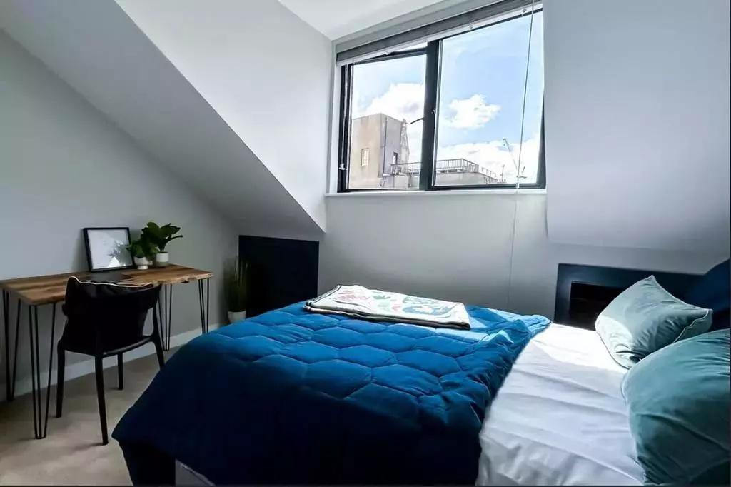 Bright and cozy double bedroom featuring a comf...