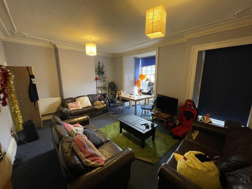 A spacious living room featuring comfortable le...