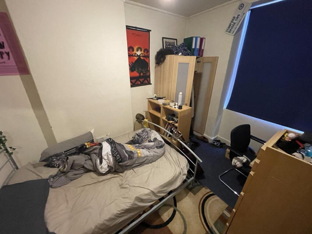 Cozy double bedroom featuring a comfortable bed...