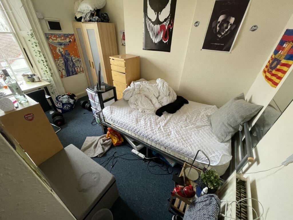 Cozy double bedroom featuring a comfortable bed...