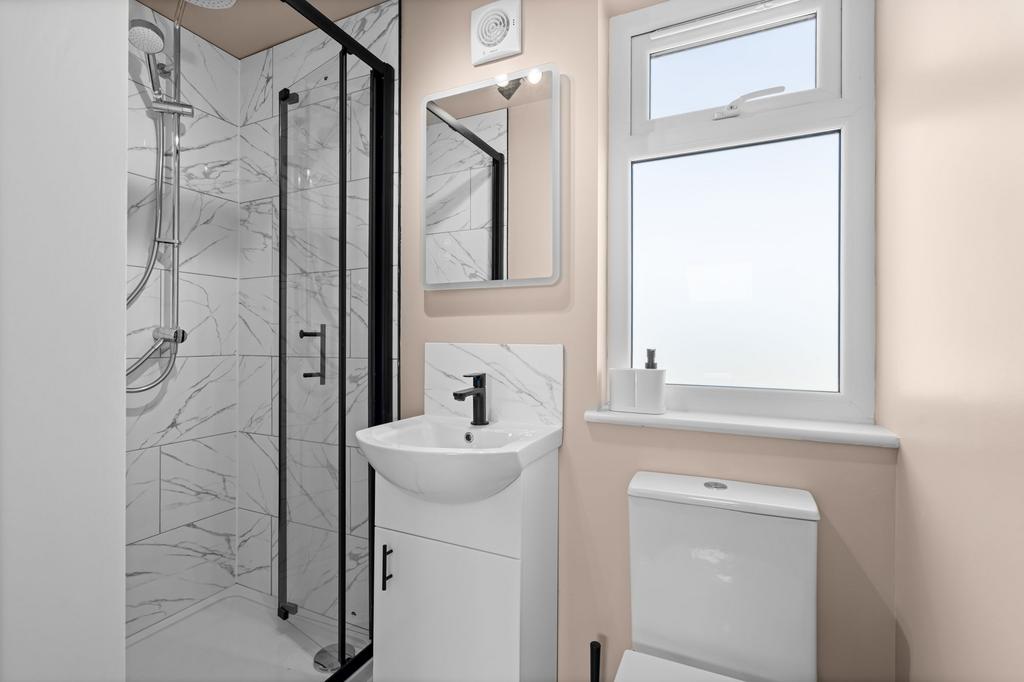 A modern bathroom featuring a sleek walk-in sho...