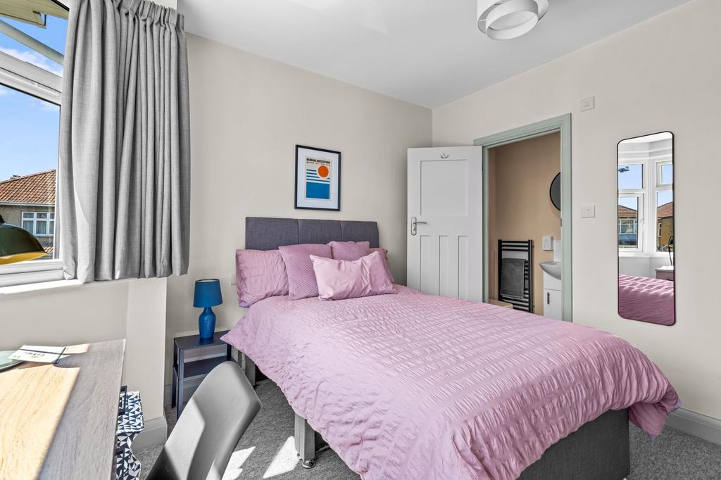 Bright and tidy double bedroom featuring a comf...