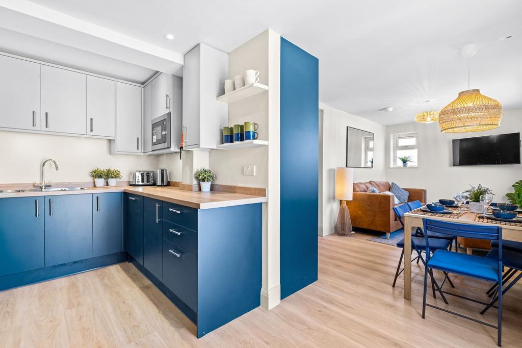 Bright and modern kitchen with stylish blue cab...