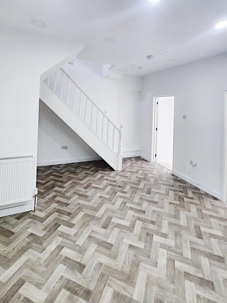 Bright, newly refurbished living area with mode...