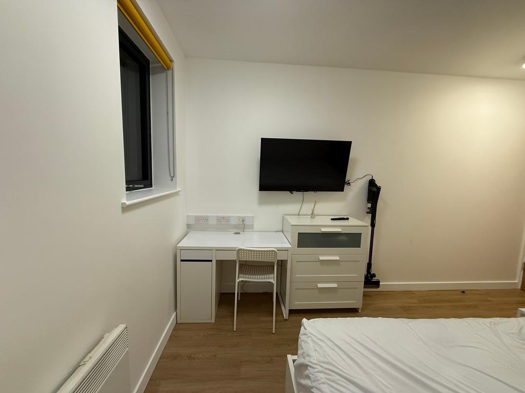 This inviting double bedroom features a comfort...