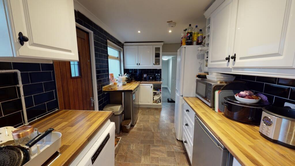 This inviting kitchen features modern cabinetry...