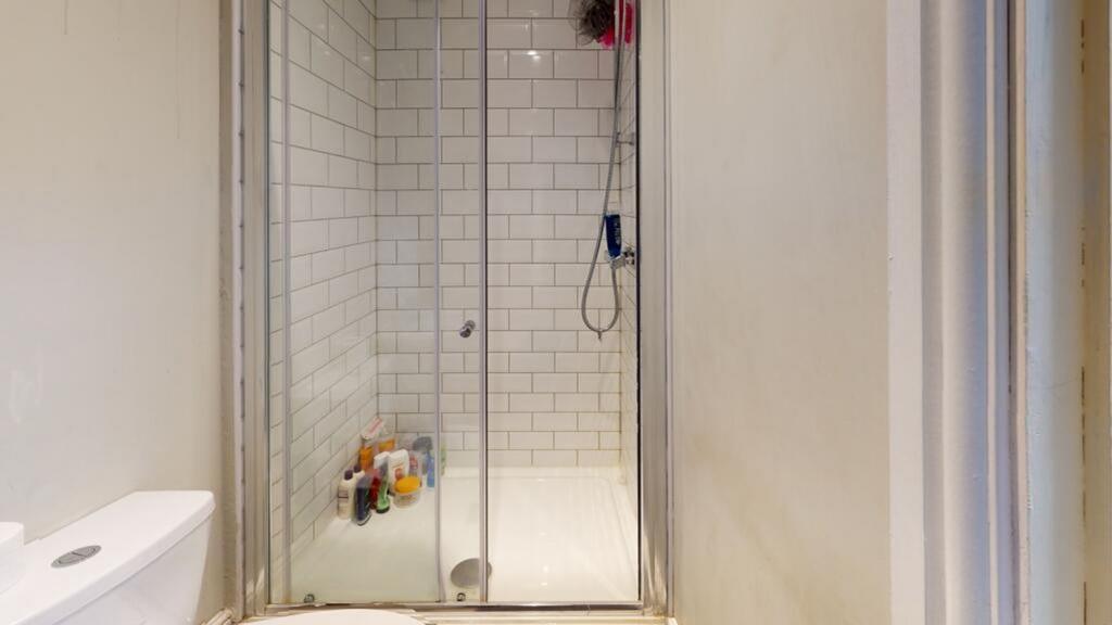 A modern bathroom featuring a sleek shower encl...