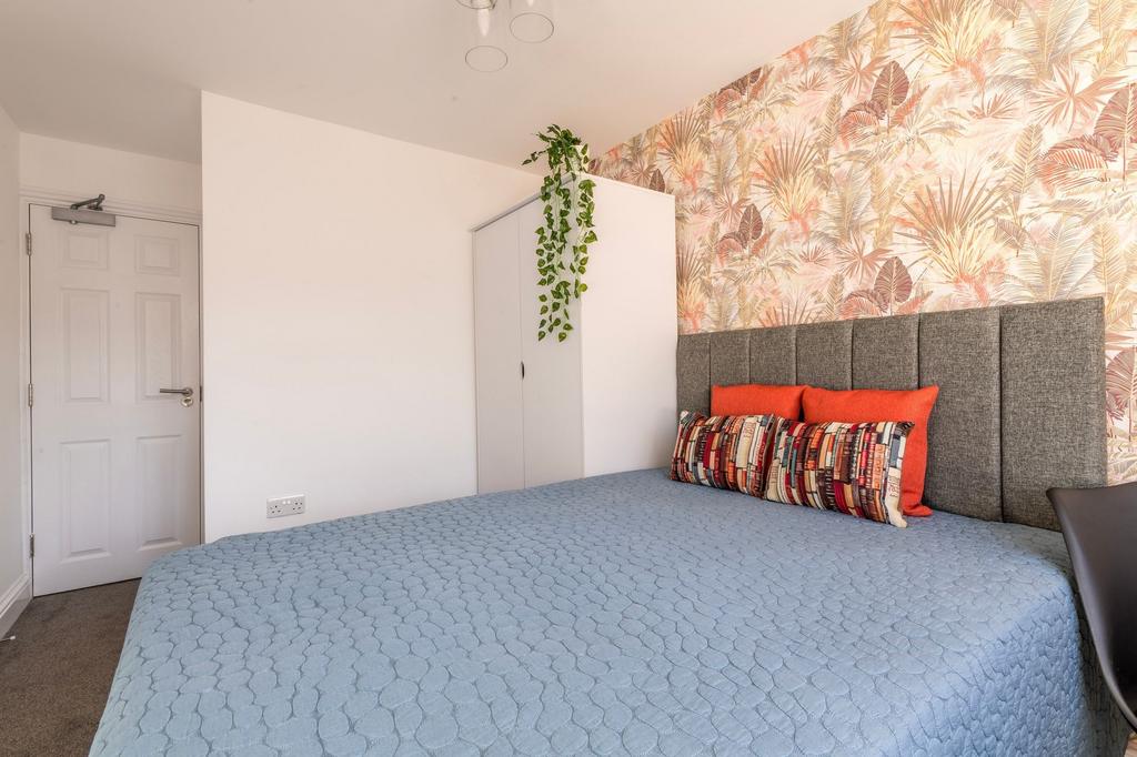 This charming double bedroom features a cozy at...