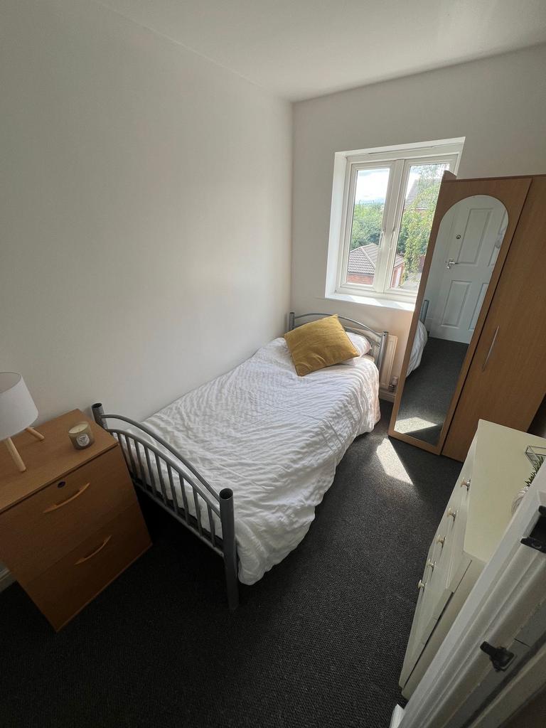 A bright and tidy single bedroom featuring a co...