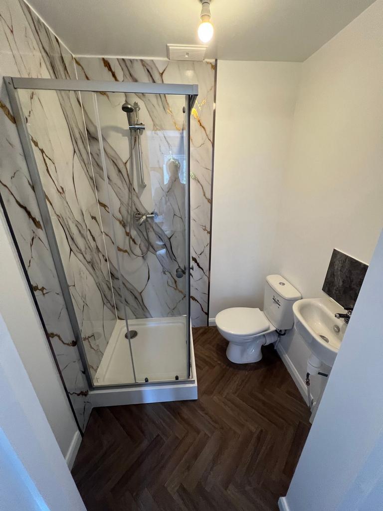 A modern bathroom featuring a stylish shower en...