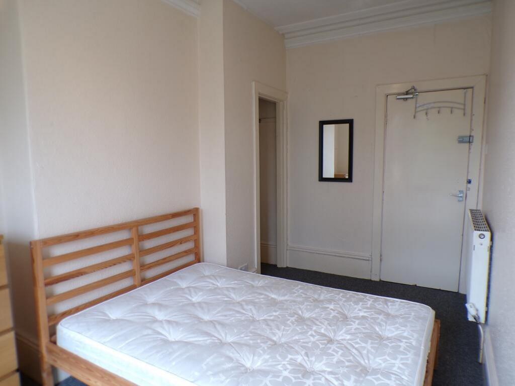 Spacious double bedroom featuring a minimalist ...