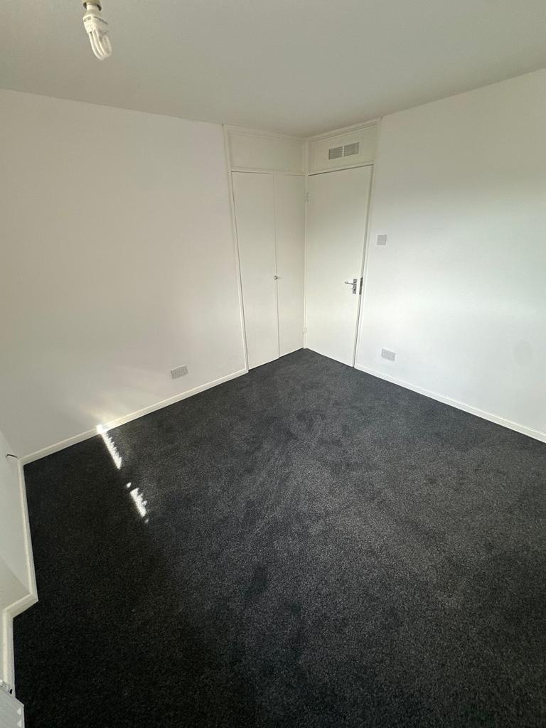 A clean and simple room with fresh white walls ...
