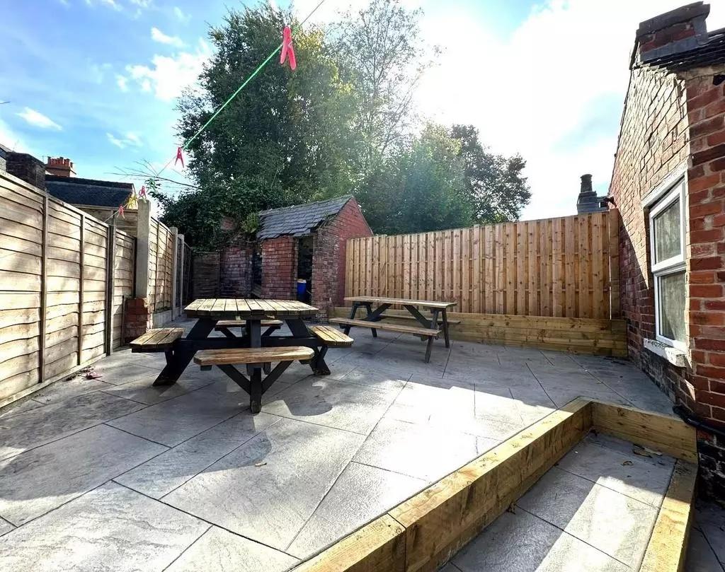 A bright and spacious outdoor garden area featu...