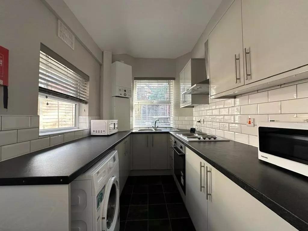 Modern galley kitchen with ample counter space,...