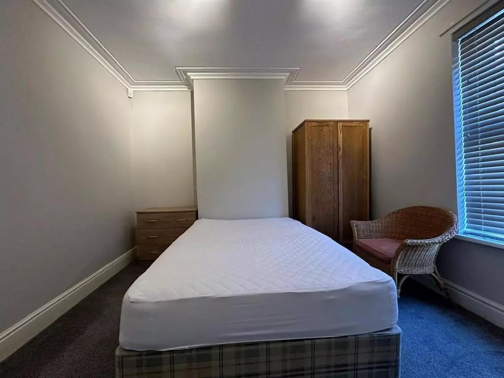 A tidy double bedroom featuring a comfortable b...