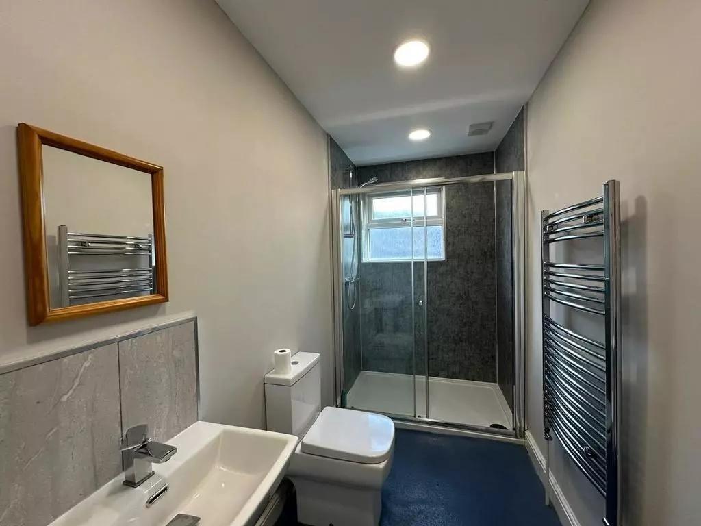 Modern bathroom featuring a sleek walk-in showe...