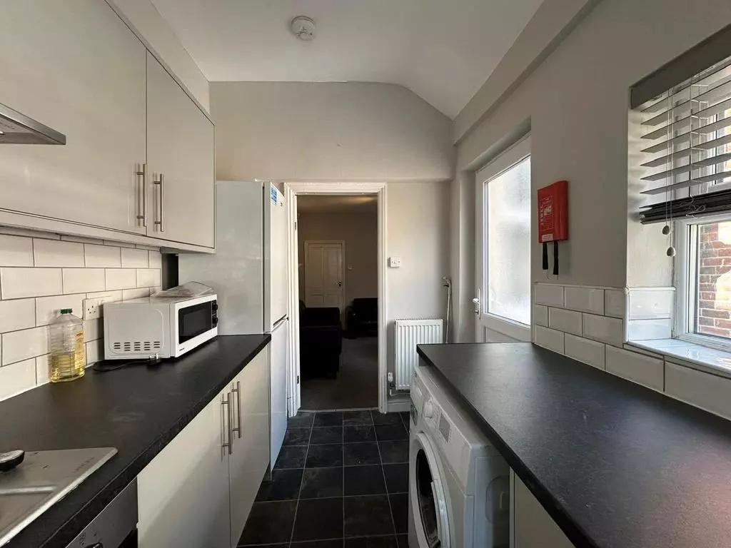 Bright and clean kitchen featuring modern white...